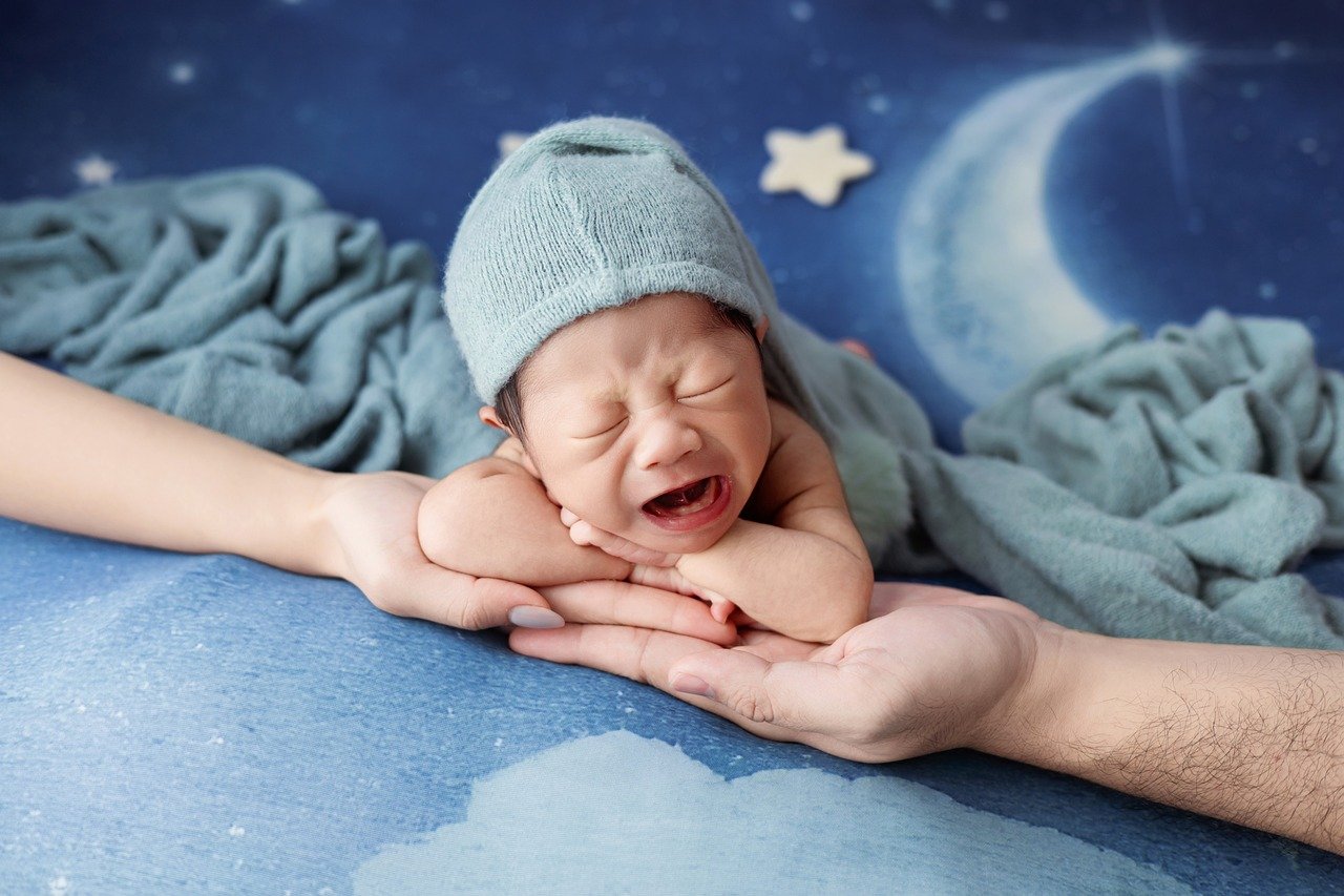 Parent comforting a baby in a peaceful nursery setting